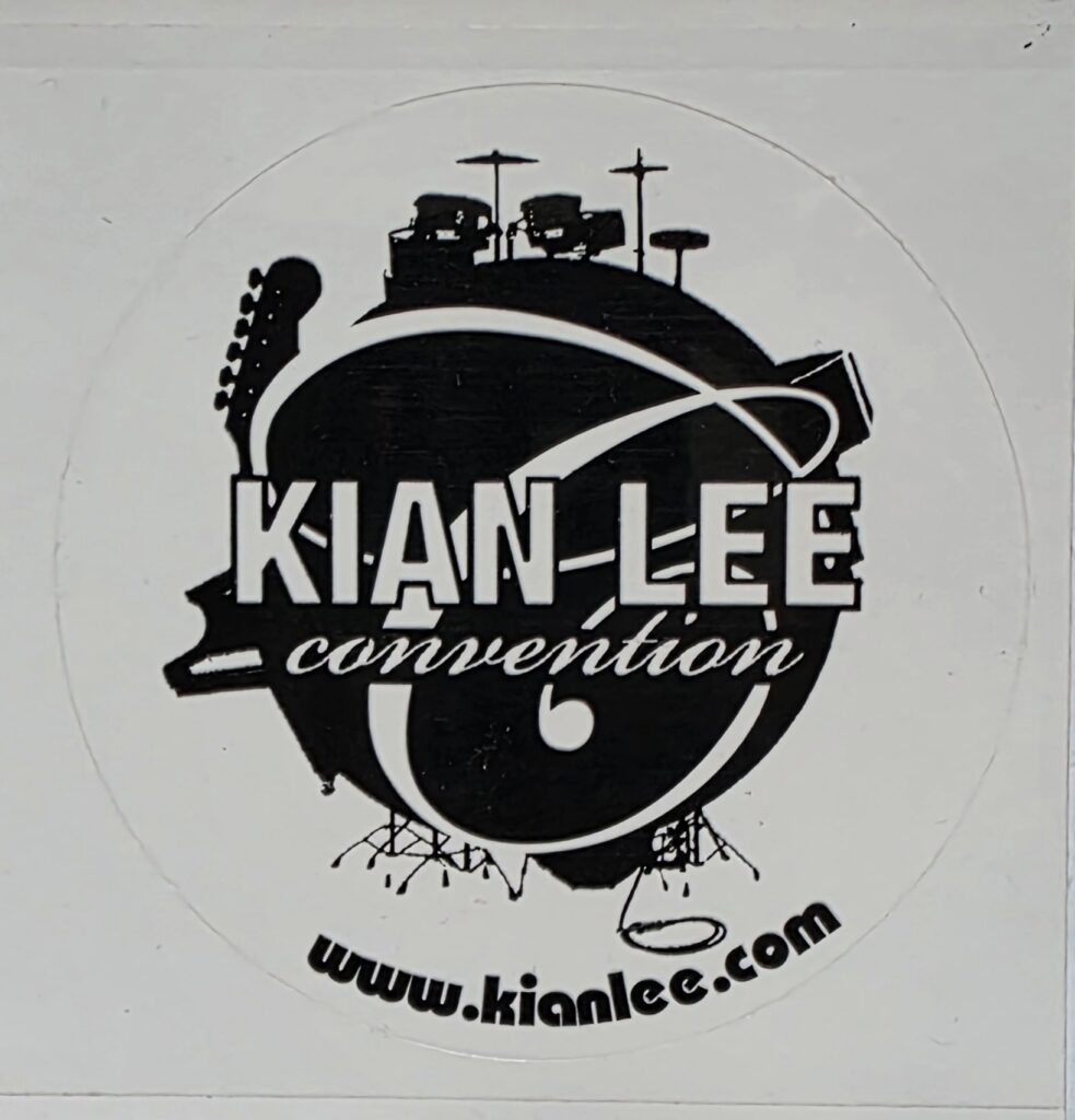 Black-and-white circular Kian Lee Convention logo combining musical instruments and the project name.