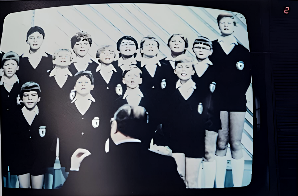 Schöneberger Sängerknaben shown on a television monitor during a ZDF broadcast of Sonntagskonzert auf Tournee.