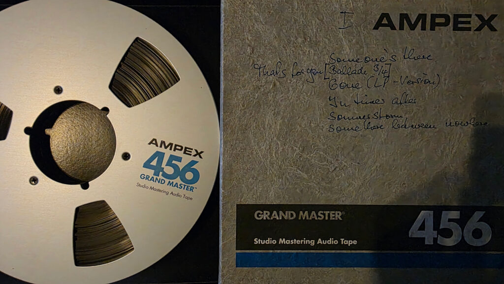 Original analogue master tape for Kian Lee Convention with handwritten session notes on the tape box.